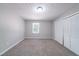 Neutral bedroom featuring carpet floors, natural light, and a closet with louvered doors at 210 Meadowbrook Dr, Mcdonough, GA 30253