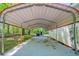 Covered carport providing protection and convenient access to the home, alongside extra storage unit at 210 Meadowbrook Dr, Mcdonough, GA 30253