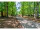 Ranch home with a charming front porch, nestled among mature trees and a long drive at 210 Meadowbrook Dr, Mcdonough, GA 30253