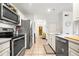Modern kitchen with stainless steel appliances, white cabinets, and tile flooring at 1101 Juniper Ne St # 1519, Atlanta, GA 30309