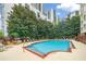 This outdoor pool is surrounded by lounge chairs and mature trees at 1101 Juniper Ne St # 1519, Atlanta, GA 30309