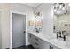 Stylish bathroom with a glass-enclosed shower, double sinks with marble countertops, and modern lighting at 1331 Iverson Ne St # A, Atlanta, GA 30307