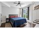 Well-lit bedroom features a comfortable bed, ceiling fan, and view of the backyard at 1331 Iverson Ne St # A, Atlanta, GA 30307