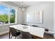 Modern dining room with large windows offering a scenic view and a contemporary chandelier above the dining table at 1331 Iverson Ne St # A, Atlanta, GA 30307