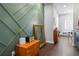 Hallway showcasing a decorative green wall, wooden floors, and contemporary decor, creating a warm welcome at 1331 Iverson Ne St # A, Atlanta, GA 30307