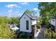 Striking modern home with white siding, dark trim, lush landscaping, and private driveway on a sunny day at 1331 Iverson Ne St # A, Atlanta, GA 30307
