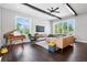 Bright living room with dark hardwood floors, piano, modern furniture, and ample natural light at 1331 Iverson Ne St # A, Atlanta, GA 30307
