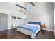 Bright main bedroom featuring high ceilings, exposed beams, and a large bed with stylish blue accents at 1331 Iverson Ne St # A, Atlanta, GA 30307