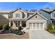 Charming two-story home features a manicured front yard, a two-car garage, and Craftsman-style architectural details at 144 Still Pine Bnd, Smyrna, GA 30082