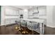 Bright kitchen boasts granite countertops, stainless steel appliances, and a spacious island with bar stool seating at 144 Still Pine Bnd, Smyrna, GA 30082