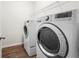 Laundry room featuring a washer, a dryer, and storage shelves at 144 Still Pine Bnd, Smyrna, GA 30082