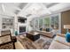 Inviting living room with fireplace, built-in shelves, abundant natural light, and decorative ceiling at 144 Still Pine Bnd, Smyrna, GA 30082