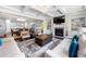 Open-concept living room features a fireplace, built-in shelving, and seamless flow to the kitchen and dining area at 144 Still Pine Bnd, Smyrna, GA 30082