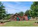 Well-maintained playground featuring slides, climbing wall, and open green space at 144 Still Pine Bnd, Smyrna, GA 30082