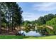 Picturesque pond with a fountain creates a serene community setting and natural beauty at 144 Still Pine Bnd, Smyrna, GA 30082