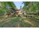 Large backyard with retaining wall and screened in porch at 160 Winter Park Ln, Powder Springs, GA 30127