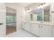Bright bathroom with double sink vanity, tile floors, view into Primary bedroom at 160 Winter Park Ln, Powder Springs, GA 30127