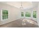 Spacious bedroom featuring a tray ceiling, carpet flooring, and large windows at 160 Winter Park Ln, Powder Springs, GA 30127