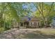 Charming single-story home featuring a welcoming front porch and beautiful, mature landscaping at 160 Winter Park Ln, Powder Springs, GA 30127
