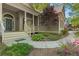 Covered front porch with stone pathway surrounded by well maintained landscaped features at 160 Winter Park Ln, Powder Springs, GA 30127