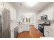 Bright kitchen with white cabinetry, stainless steel appliances and hardwood floors at 160 Winter Park Ln, Powder Springs, GA 30127