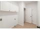 Laundry room with storage cabinets and tile flooring at 160 Winter Park Ln, Powder Springs, GA 30127