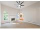 Bright living room featuring a fireplace, arched windows, and a modern ceiling fan at 160 Winter Park Ln, Powder Springs, GA 30127
