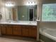 Bathroom featuring double sinks, lots of counter space, and a soaking tub at 33 Ashland Cir, Douglasville, GA 30134