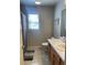 Neutral bathroom featuring a single vanity, toilet, and shower with a window for natural light at 33 Ashland Cir, Douglasville, GA 30134