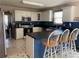 Stylish kitchen with white cabinetry, black countertops, and stainless appliances, plus eat-in breakfast bar at 33 Ashland Cir, Douglasville, GA 30134