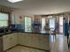 Bright eat-in kitchen with white cabinetry, black countertops, and adjacent dining space at 33 Ashland Cir, Douglasville, GA 30134