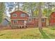 Exterior view of a two-story home featuring a wood deck and spacious backyard at 5350 Rockbridge Rd, Stone Mountain, GA 30088