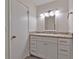 Bathroom with neutral countertop, white cabinets and a four-bulb vanity at 5350 Rockbridge Rd, Stone Mountain, GA 30088