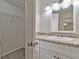 Bright bathroom featuring a white vanity with a granite countertop and a view into the closet at 5350 Rockbridge Rd, Stone Mountain, GA 30088