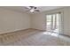 Bedroom with neutral carpet, ceiling fan, and sliding glass door at 5350 Rockbridge Rd, Stone Mountain, GA 30088