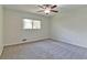 A bedroom offering a serene space with soft carpet and natural light streaming in through a window at 5350 Rockbridge Rd, Stone Mountain, GA 30088