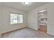 Bright dining room with neutral walls, plush carpet and views of backyard through large window at 5350 Rockbridge Rd, Stone Mountain, GA 30088