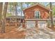 Charming two-story home with a stone-accented garage and black trimmed windows at 5350 Rockbridge Rd, Stone Mountain, GA 30088