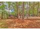 Scenic view of a brown two-story home surrounded by mature trees and a sprawling yard at 5350 Rockbridge Rd, Stone Mountain, GA 30088