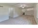 Spacious living room with carpet, white walls, and staircase at 5350 Rockbridge Rd, Stone Mountain, GA 30088