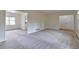 Spacious living room with neutral walls, carpet, and open doorway to another room at 5350 Rockbridge Rd, Stone Mountain, GA 30088