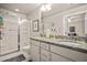 Bright bathroom featuring a granite countertop, white cabinetry, and glass-enclosed shower at 6322 Scudders Dr, Lithonia, GA 30058