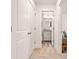 Bright hallway leading to a bathroom with granite countertop and light gray cabinets at 6322 Scudders Dr, Lithonia, GA 30058