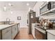 Galley-style kitchen with stainless steel appliances and white countertops, offering ample space and modern design at 6322 Scudders Dr, Lithonia, GA 30058