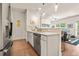 Modern kitchen featuring stainless steel appliances, white cabinets, and open layout to the living room at 6322 Scudders Dr, Lithonia, GA 30058