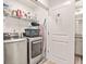 Modern laundry room with stainless steel washer and dryer, and ample storage at 6322 Scudders Dr, Lithonia, GA 30058