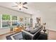 Bright living room featuring hardwood floors, large windows, and a comfortable leather sofa at 6322 Scudders Dr, Lithonia, GA 30058
