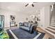 Spacious living area with hardwood floors, leather sofa, and open floor plan to kitchen at 6322 Scudders Dr, Lithonia, GA 30058