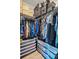 Organized walk-in closet with ample shelving, hanging space, and storage bins at 6322 Scudders Dr, Lithonia, GA 30058