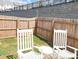 Private backyard retreat with a fenced yard and comfortable rocking chairs, perfect for relaxation at 251 Turner Ln, Woodstock, GA 30188